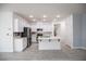 Bright, open kitchen with white cabinets, stainless steel appliances, and a center island at 6925 Cuddy Falls Pl, North Las Vegas, NV 89084