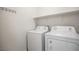 Efficient laundry room equipped with a washer, dryer, and convenient shelving at 6925 Cuddy Falls Pl, North Las Vegas, NV 89084