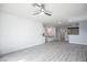Spacious living room with open floor plan, hardwood floors, and modern lighting fixtures at 6925 Cuddy Falls Pl, North Las Vegas, NV 89084