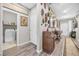 Hallway with decor art and access to a laundry room, complete with wood-look flooring at 7148 Stanley Frederick St, Las Vegas, NV 89166