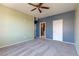 Large bedroom features a ceiling fan, neutral carpet, and multiple doors for flexible access at 7155 S Durango Dr # 303, Las Vegas, NV 89113