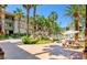 Picturesque community area featuring a water feature, lush greenery, seating area, and desert landscaping at 7155 S Durango Dr # 303, Las Vegas, NV 89113