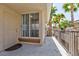 Exterior entrance to condo unit with a private patio and palm trees, creating a welcoming atmosphere at 7155 S Durango Dr # 303, Las Vegas, NV 89113