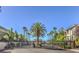 Daytime view of community entry gate and surrounding palm trees and landscaping at 7155 S Durango Dr # 303, Las Vegas, NV 89113