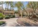 Outdoor picnic area with barbecues and covered seating amid lush greenery and palm trees at 7155 S Durango Dr # 303, Las Vegas, NV 89113