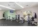Fitness center with multiple exercise machines, television, and large windows at 7155 S Durango Dr # 303, Las Vegas, NV 89113