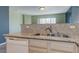 Kitchen featuring stainless steel sink, neutral granite countertop, wood cabinets and dishwasher at 7155 S Durango Dr # 303, Las Vegas, NV 89113