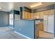 Kitchen features a breakfast bar, white appliances, and light wood cabinets with granite countertops at 7155 S Durango Dr # 303, Las Vegas, NV 89113