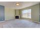 Bright living room with large window, fireplace, and plush carpeting, perfect for relaxation and comfort at 7155 S Durango Dr # 303, Las Vegas, NV 89113