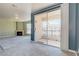 Spacious living room features a sliding glass door with exterior views and a cozy fireplace in the corner at 7155 S Durango Dr # 303, Las Vegas, NV 89113