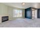 Comfortable living room with fireplace, light green accent wall and large windows offering natural light at 7155 S Durango Dr # 303, Las Vegas, NV 89113