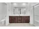 Modern bathroom features a double sink vanity, large mirror, and glass-enclosed shower at 752 Echelon St, Las Vegas, NV 89138