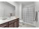 Well-lit bathroom features a large vanity, shower, and crisp, clean white and brown color palette at 752 Echelon St, Las Vegas, NV 89138