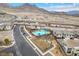 Aerial view of the community pool with lounge chairs and nearby modern home construction at 752 Echelon St, Las Vegas, NV 89138