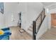 Open-concept foyer featuring stairs, wood flooring, high ceilings and modern decor at 752 Echelon St, Las Vegas, NV 89138