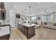 Bright, open-concept kitchen with stainless appliances, an island with seating and access to the living room at 752 Echelon St, Las Vegas, NV 89138