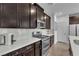 Kitchen featuring a gas range, stainless appliances, white countertops and dark cabinets at 752 Echelon St, Las Vegas, NV 89138