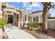 Elegant front entrance with stone accents and lush landscaping at 800 Jody Brook Ct, Las Vegas, NV 89145