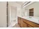 Bright bathroom with a dual sink vanity and a separate room featuring a toilet and a tub/shower at 8787 Roping Rodeo Ave # 101, Las Vegas, NV 89178