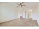 Sunlit bedroom with neutral carpet, connecting to both a walk-in closet and a bathroom at 8787 Roping Rodeo Ave # 101, Las Vegas, NV 89178