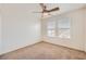 Bedroom with carpet, ceiling fan, and windows, creating a bright and comfortable living space at 8787 Roping Rodeo Ave # 101, Las Vegas, NV 89178