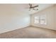 Cozy bedroom with soft carpet, a ceiling fan, and sunlit windows offering neighborhood views at 8787 Roping Rodeo Ave # 101, Las Vegas, NV 89178