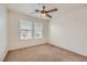 Carpeted bedroom featuring two windows and a ceiling fan at 8787 Roping Rodeo Ave # 101, Las Vegas, NV 89178