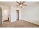 A bedroom with plush carpeting, ceiling fan, closet and attached bathroom at 8787 Roping Rodeo Ave # 101, Las Vegas, NV 89178