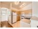 Well-lit kitchen featuring wooden cabinets and appliances, tile flooring, and ample countertop space at 8787 Roping Rodeo Ave # 101, Las Vegas, NV 89178