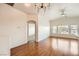 Bright, open living room with wood floors, many windows, and an archway to another room at 8787 Roping Rodeo Ave # 101, Las Vegas, NV 89178