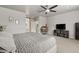 Inviting bedroom featuring a TV, ceiling fan, and neutral decor at 896 Janefield St, Las Vegas, NV 89148