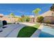 Expansive backyard featuring an in-ground pool, lush greenery, and a patio area for outdoor enjoyment at 9108 Tuxpan St, Las Vegas, NV 89131