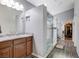 Bathroom with dual sinks, marble countertops, glass shower, and closet at 9108 Tuxpan St, Las Vegas, NV 89131