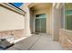 Covered entrance highlights a stylish double door entry framed by stone accents at 9108 Tuxpan St, Las Vegas, NV 89131