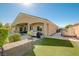 Exterior view of the house showcasing the covered patio, built-in grill, and side yard with trailer parking at 9108 Tuxpan St, Las Vegas, NV 89131