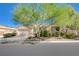 Inviting home showcases desert landscaping, a mature shade tree, and an attached two-car garage at 9108 Tuxpan St, Las Vegas, NV 89131