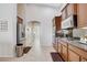 Modern kitchen with stainless steel appliances, granite countertops, and access to laundry area at 9108 Tuxpan St, Las Vegas, NV 89131