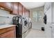 Functional laundry room with front load washer and dryer, built-in cabinets, and sink at 9108 Tuxpan St, Las Vegas, NV 89131