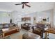 Comfortable living room featuring leather seating, ceiling fan, and an open floor plan with sightlines to kitchen and dining area at 9108 Tuxpan St, Las Vegas, NV 89131