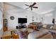 Open-concept living room with high ceilings, tile flooring, and a comfortable seating arrangement at 9108 Tuxpan St, Las Vegas, NV 89131