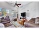 Comfortable living room features vaulted ceilings, a ceiling fan, and direct access to the backyard at 9108 Tuxpan St, Las Vegas, NV 89131