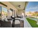 Inviting outdoor patio with wicker furniture and access to manicured lawn and refreshing pool area at 9108 Tuxpan St, Las Vegas, NV 89131