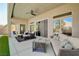 Covered patio with comfortable seating, ceiling fan, and sliding glass doors leading to the indoors at 9108 Tuxpan St, Las Vegas, NV 89131