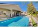 Backyard pool and patio area showcasing an outdoor kitchen, relaxing seating, and lush greenery at 9108 Tuxpan St, Las Vegas, NV 89131
