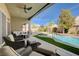 Luxury backyard with sparkling pool, manicured artificial turf, patio furniture, and serene landscaping at 9108 Tuxpan St, Las Vegas, NV 89131