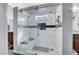 Spacious walk-in shower with dual shower heads, bench, and decorative tile accents at 9108 Tuxpan St, Las Vegas, NV 89131