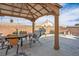 Spacious backyard with covered patio area, grill, and hammock at 938 Carnival Ave, Las Vegas, NV 89123