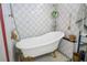 Charming bathroom showcasing a clawfoot tub, and white tile surround at 938 Carnival Ave, Las Vegas, NV 89123