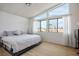 Bright bedroom with hardwood floors and ample natural light from the large windows with view of terracotta roof at 938 Carnival Ave, Las Vegas, NV 89123