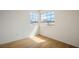 Bright bedroom with natural light coming through two windows and light hardwood floors at 938 Carnival Ave, Las Vegas, NV 89123